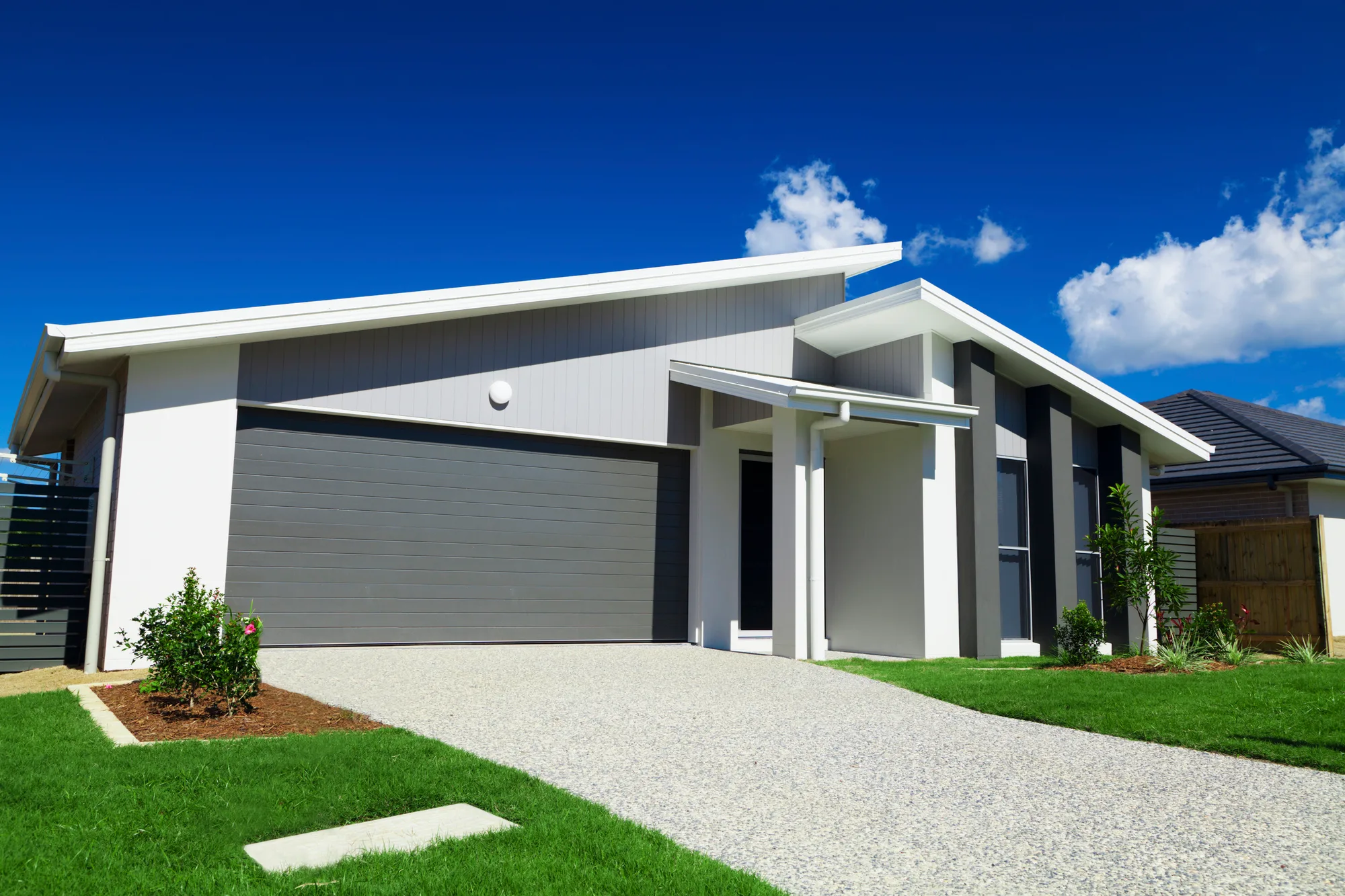Wide concrete driveway with a garage