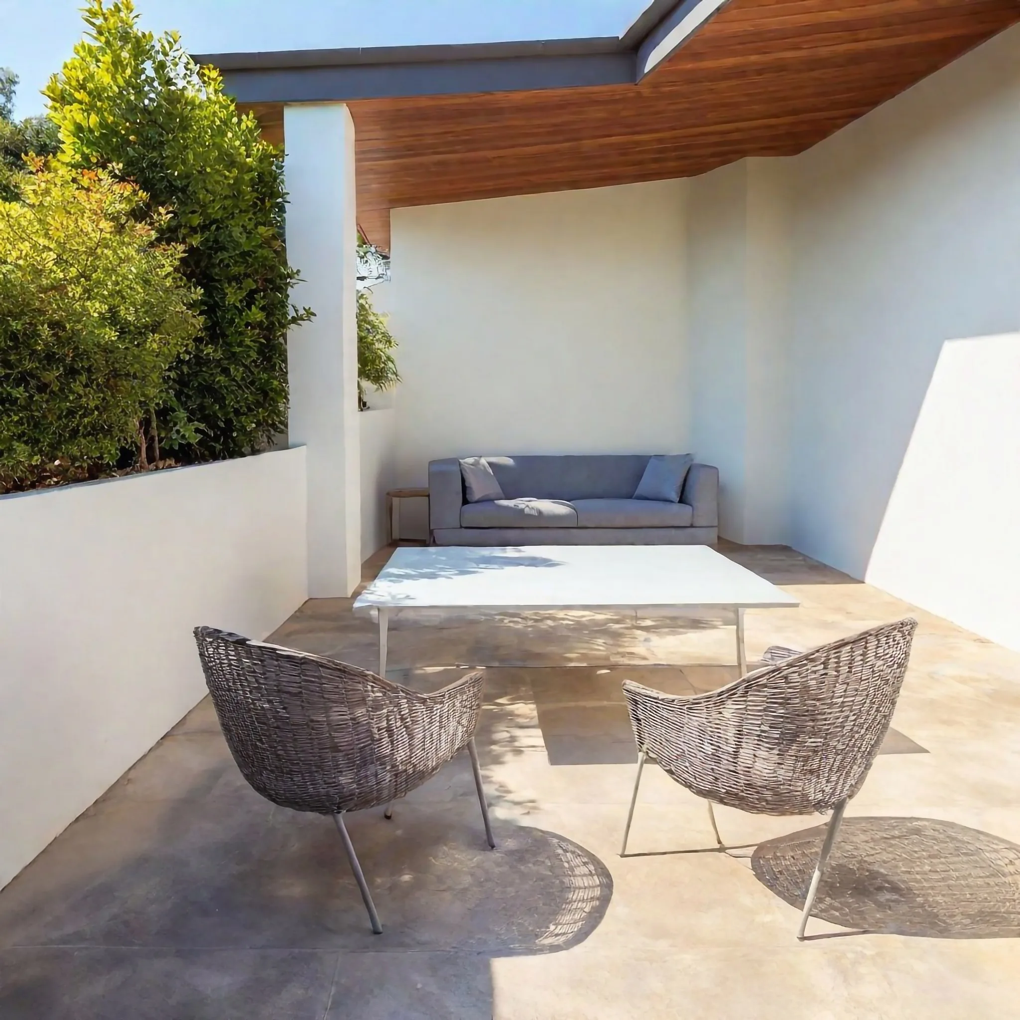 Covered concrete patio with outdoor furniture